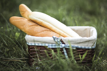 Baguette in a basket on the grass