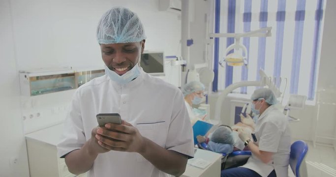 dental assistant typs on smartphone in office