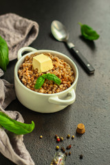 buckwheat porridge and a piece of butter (delicious food) homemade dish. food background. top