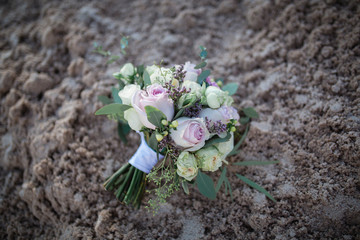 wedding bouquet with roses on sand