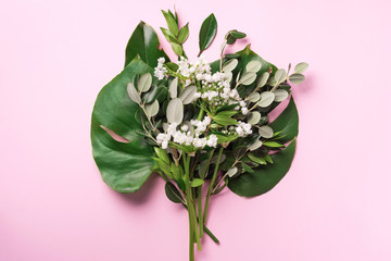 Spring flowers and tropical monstera leaves. Floral composition, creative layout. Flat lay, top view. Spring, summer or garden concept. Present for Woman day