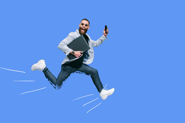 Positive handsome young businessman running in the air along an empty wall. Crazy emotions.