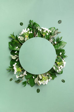 Fototapeta Creative layout made of tropical leaves and white flowers on green background. Top view. Flat lay. Summer or spring nature concept. Blank for advertising card or invitation. Mock up