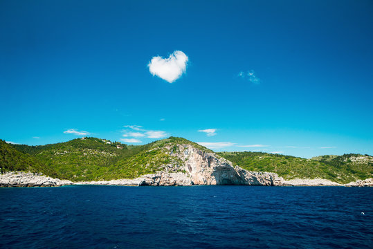 Cloud in the form of a heart over the island near the open sea, Greece, Paxos islend