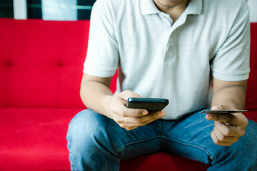 Man's hands holding shopping and credit card manage online payment by using smart phone