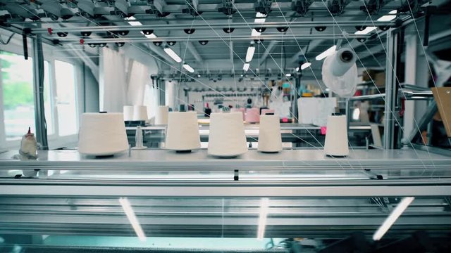 View of working knitting machine in workshop
