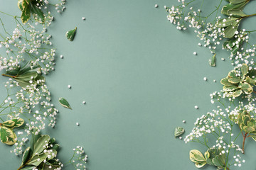 Small white gypsophila flowers on pastel green background. Women's Day, Mother's Day, Valentine's Day, Wedding concept. Flat lay. Top view. Copy space - 270215360