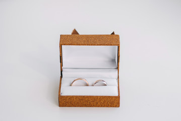 rings in a box on a white background. before the wedding and the wedding