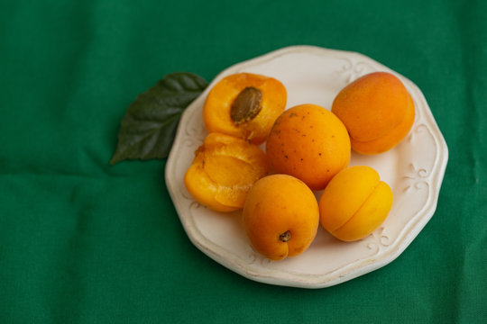 Apricots On A Plate, Dark Green Tablecloth