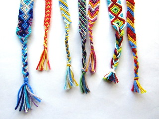 friendship bracelets made of thread with braids on white background	