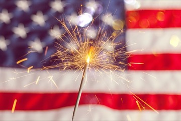 Sparkler and usa flag showing 4th of july - obrazy, fototapety, plakaty