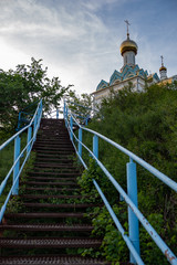 blue metal staircase with steps leading to the temple which stands on the mountain