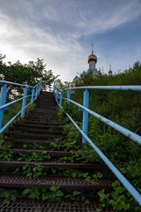 blue metal staircase with steps leading to the temple which stands on the mountain