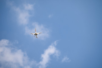 Unmanned uav aircraft for filming with flying in blue sky