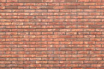 The walls of the facing decorative brick dark red color. Abstract background.