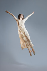 Dancer makes the jump. Isolation on a gray background.