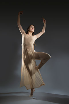 Dancer in a dress for modern dance dancing in the Studio.
