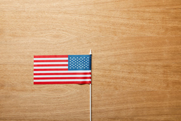 Fototapeta premium top view of american flag on wooden table with copy space