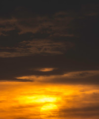 The golden light of the sun and clouds in the sky.