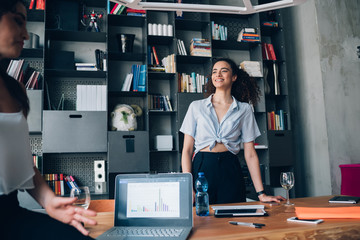 two young freelancer women having informal meeting in coworking office