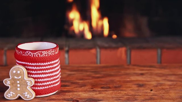 Christmas drinks on wooden table near fireplace