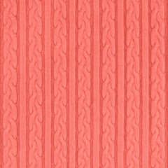 Trendy coral colored Knitwear Fabric Texture with Pigtails and stripes. Repeating Machine Knitting Texture of Sweater. Knitted Background.