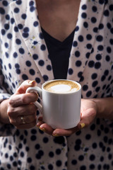A cup of coffee sutra as a way of awareness and relaxation for a modern girl
