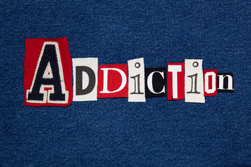 ADDICTION text word collage, colorful fabric on blue denim, health and addiction concept, horizontal aspect
