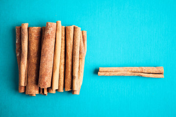 Set of cinnamon sticks on turquois background