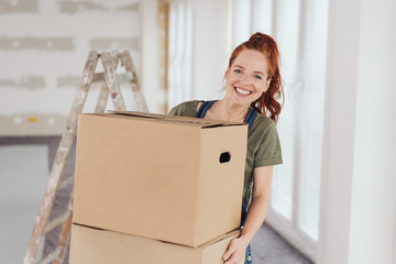Happy vivacious young woman moving house