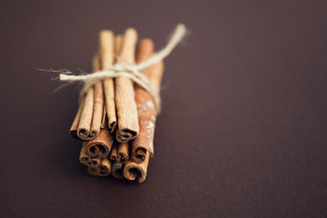 Set of cinnamon sticks on brown background