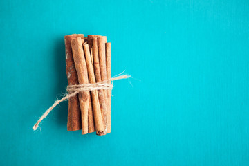 Set of cinnamon sticks on turquois background