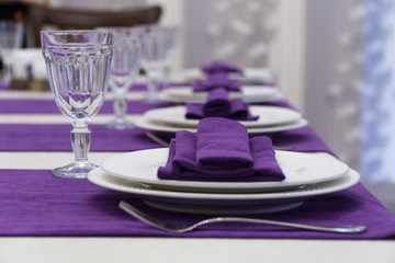 serving banquet table in a luxurious restaurant in purple and white style