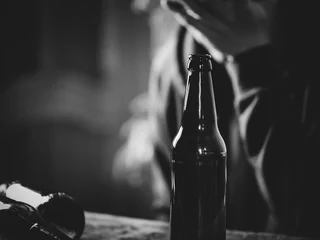 Fototapeten A man holding a bottle of beer in his hand. The concept of alcoholism and problems in life © pavelkant