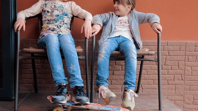  Sports and fashionable young girls with a skateboard sit in the chairs