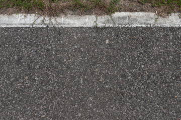 Fototapeta premium Asphalt road with stripes and green grass texture Background,empty copy space.