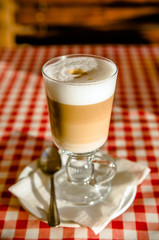 A Cup of coffee latte is on the table in the cafe 