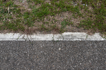 Asphalt road with stripes and green grass texture Background,empty copy space.
