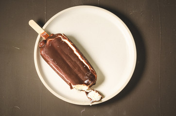 ice cream. Ice cream in chocolate glaze on a white bowl. top view. Sweet dessert
