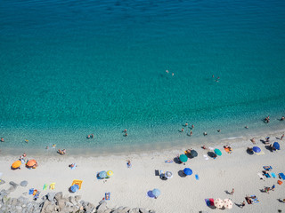 Fototapeta na wymiar Aerial view of the beach of Tropea, the amazing seaside place in Calabria, Italy. The shot is taken during a beautiful sunny summer day