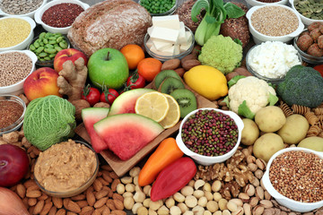 Large vegan health food selection with fruit, vegetables, bean curd, legumes, nuts, pasta, cereals, bread, grains, almond yoghurt & peanut butter. High in antioxidants, omega 3, protein & fibre.