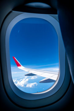  Clouds and sky as seen through window of an aircraft