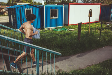 Fototapeta premium Muscular Man Running Down The Stairs