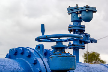 Old blue pipeline with valve. Copy space