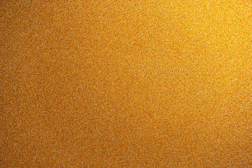 Abstract gold glitter paper texture background or backdrop. Empty shimmer paper or yellow shiny...