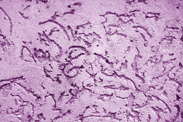 Old wall texture as background in purple color.