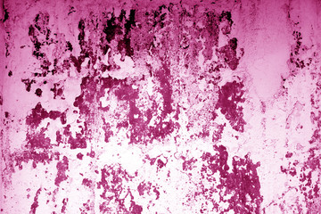 Сraked weathered cement wall texture in pink tone.