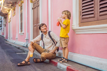 Dad and son tourists on the Street in the Portugese style Romani in Phuket Town. Also called...