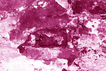 Old grungy brick wall texture in pink tone.