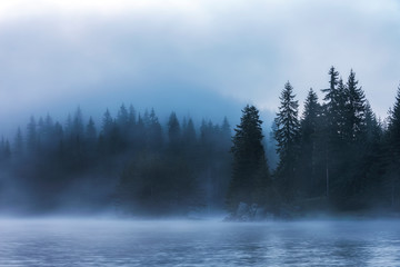 Stunning image of the foggy lake Shiroka poliana in Rhodope mountain, Bulgaria, Europe. Dramatic...